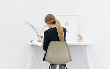 woman writing at desk